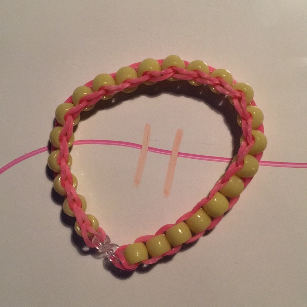 Pink band yellow bead